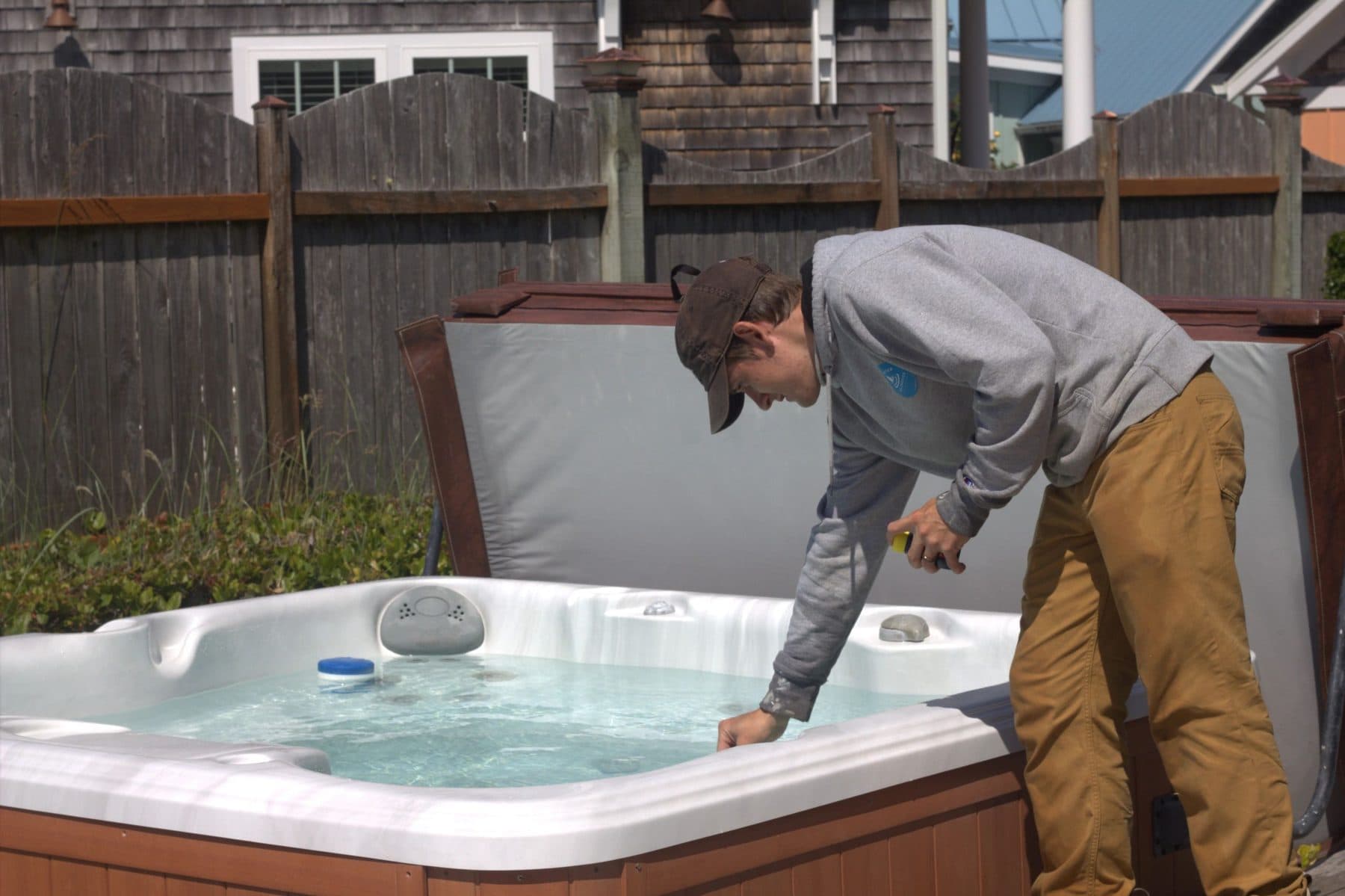 Technician testing and balancing hot tub water
